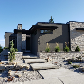 Stone walkway leading to a modern Okanagan home