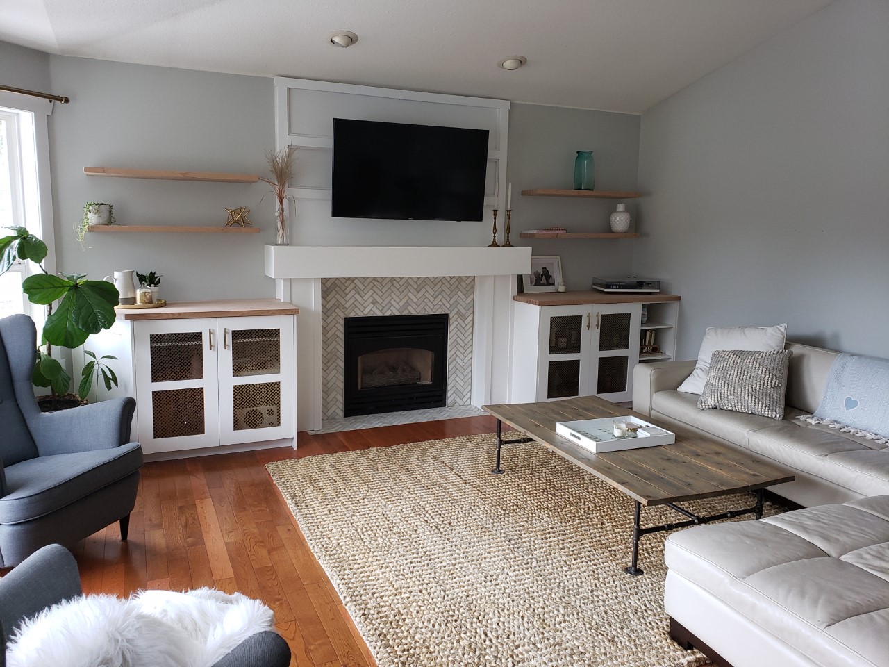 White custom built-ins framing a renovated living room fireplace